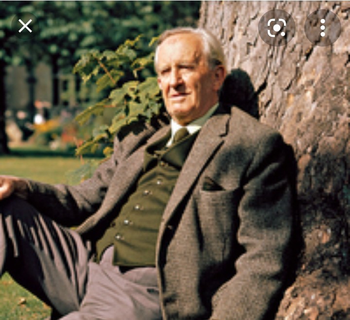 An image of J.R.R. Tolkien leaning against a tree