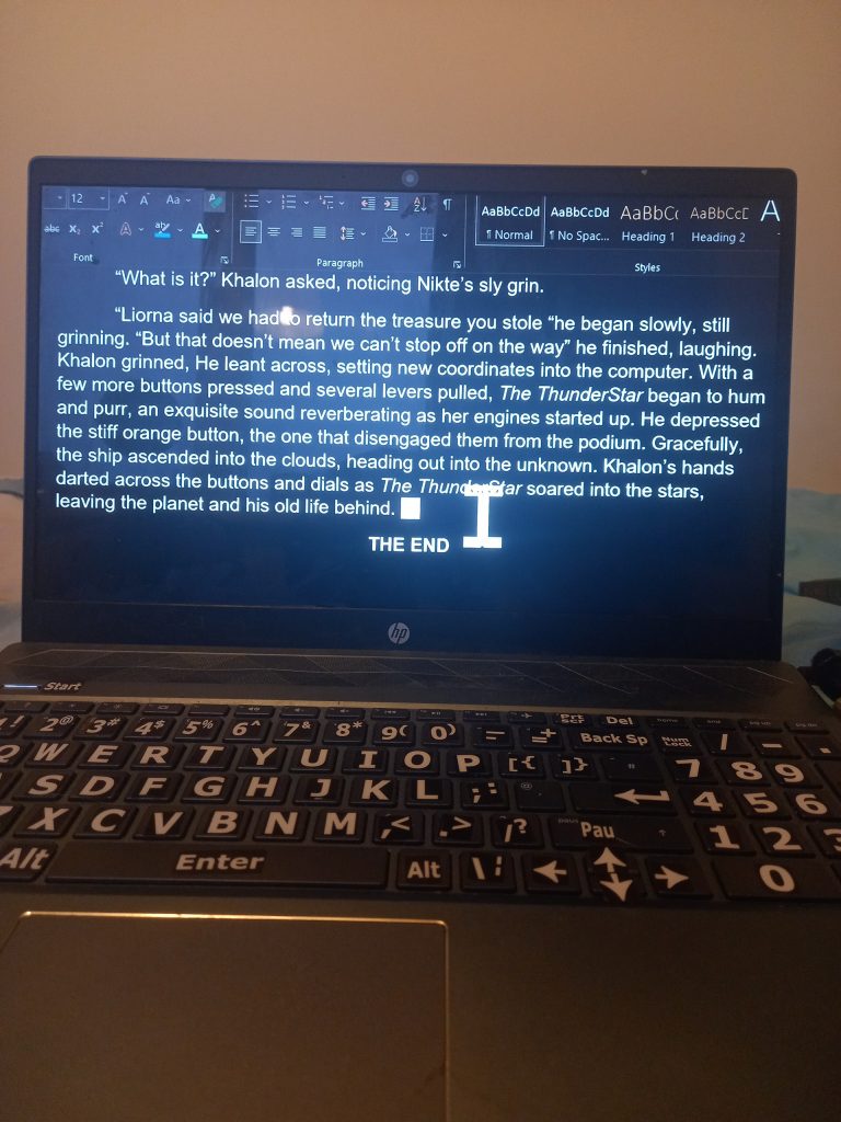  A picture of a grey laptop with writing on the screen 